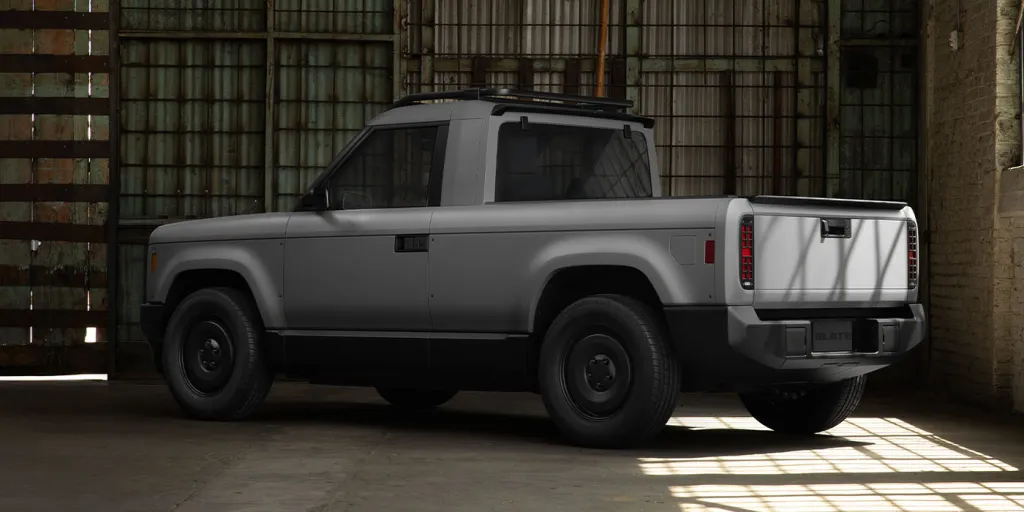 2027 Slate Truck EV in its standard gray finish, showcasing compact design and minimalist features at launch event.