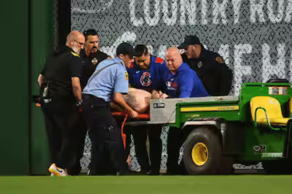 Fan lying on the warning track at PNC Park after falling from right-field stands during Pirates vs. Cubs game